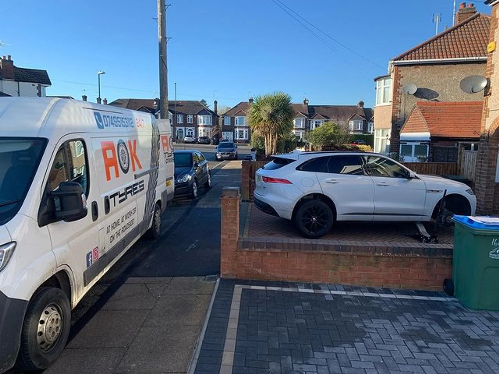 Ford on a driveway with AOK tyre van helping out.